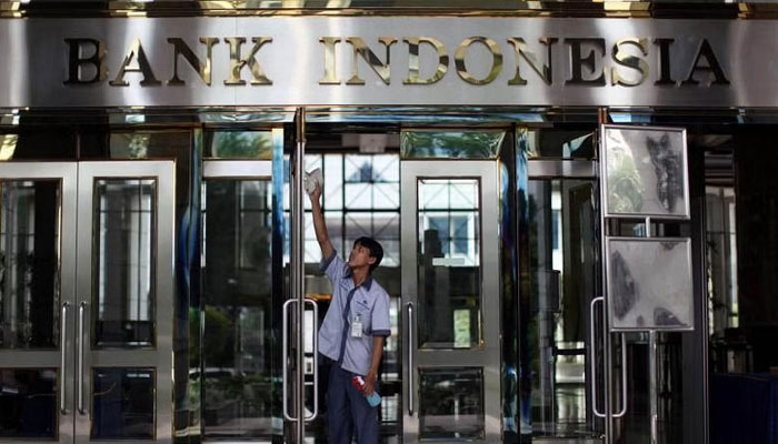 A worker cleans the entrance to the headquarters of Bank Indonesia, the nations central bank, in Jakarta, Indonesia. — BLOOMBERG