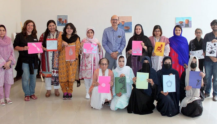 Participants pose for a group photo during the Artist Talk & Workshop on Paper Cutting part of the ‘The Guiding Light’ exhibition organized by PNCA on April 24, 2024. — Facebook/PNCA - Pakistan National Council of the Arts