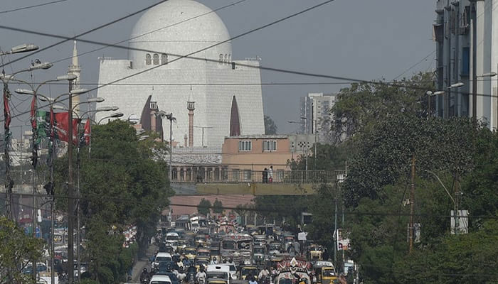 This photograph shows commuters driving on a busy street in Karachi. — AFP/File