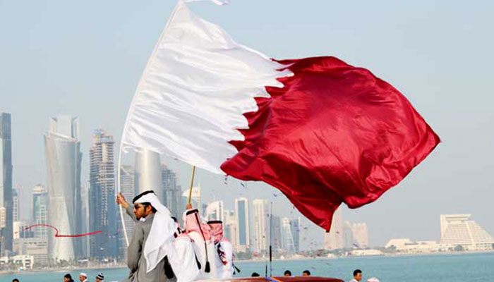 A representational image showing a person waving Qatars national flag. — AFP/File