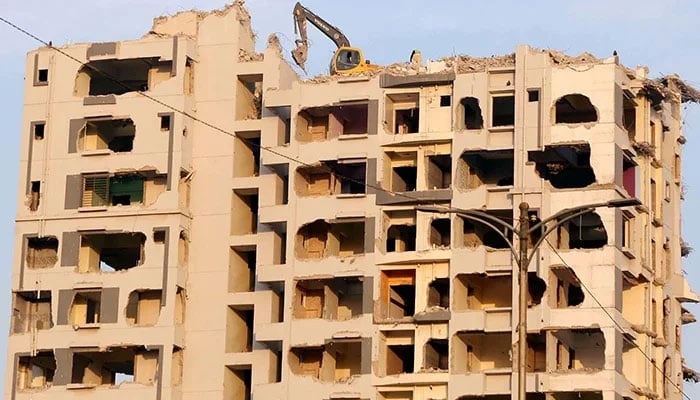 Nasla Towers demolishing works can be seen in progress on Sharea Faisal in Karachi.  — PPI/File