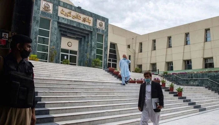 A lawyer walks past in front of the Peshawar High Court building.— AFP/File