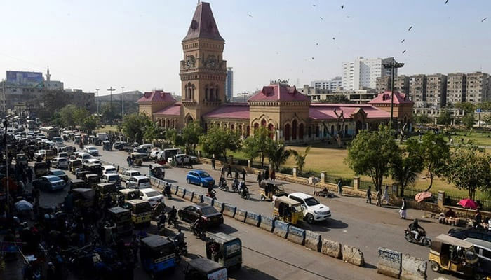 This picture taken on January 30, 2023, shows commuters passing through the Empress Market in Pakistans port city of Karachi. — AFP