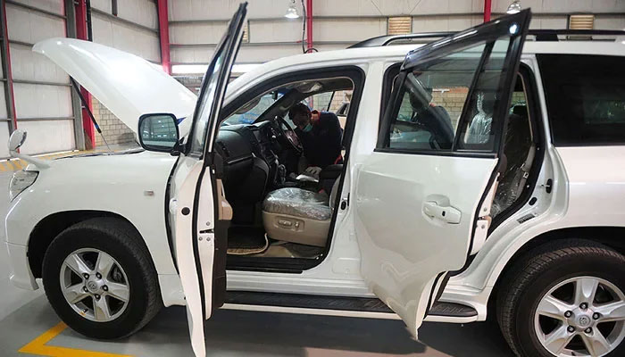 A worker checks a bullet and bombproof vehicle at a workshop. — AFP/File