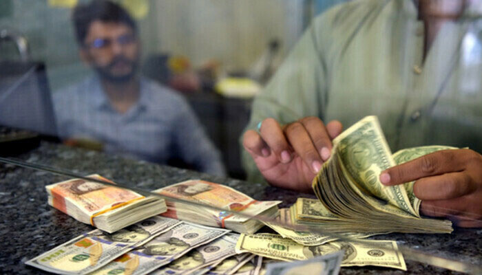 A currency dealer counting notes at an exchange company. — AFP/File