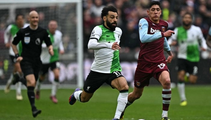 Liverpools Egyptian striker Mohamed Salah runs with the ball during the English Premier League football match between West Ham United and Liverpool at the London Stadium, in London April 27, 2024. — AFP