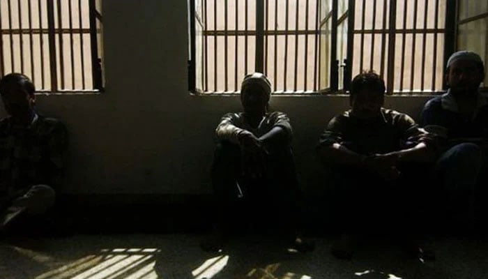 Representational image of inmates sitting inside a jail. — AFP File