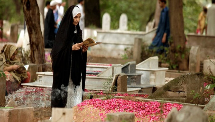 Representational image of a woman offering Fateha Khawani in a graveyard. — ANI File