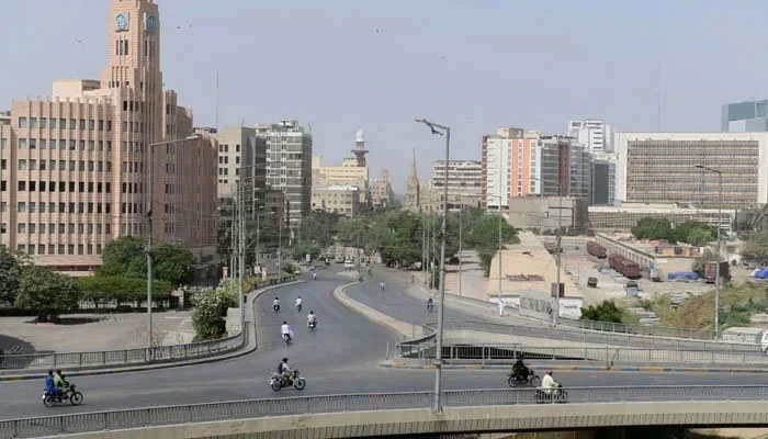 Commuters make their way through a partially deserted bridge in Karachi. — AFP/File