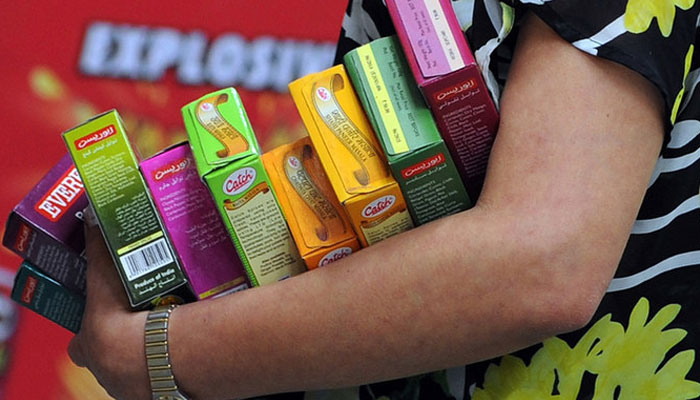 In this image, a person holds packets of spices at a supermarket in Mumbai. — AFP/File