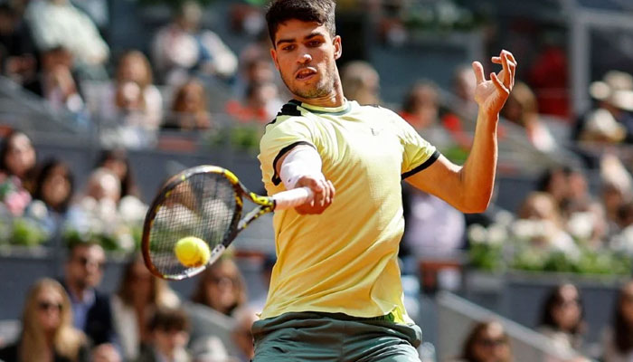 Spains Carlos Alcaraz returns to Brazils Thiago Seyboth Wild during the third round of the 2024 ATP Tour Madrid Open tournament tennis match at Caja Magica in Madrid on April 28, 2024. — AFP