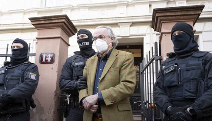 German special police forces detain Heinrich XIII Prinz Reuss after searching a house in Frankfurt, Germany on December 7, 2022. — AFP