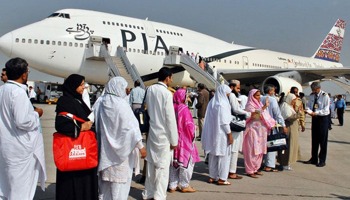 In this image, Pakistani pilgrims wait in line as they prepare to board a PIA special Haj pilgrimage flight bound for Saudi Arabia at the Allama Iqbal International Airport in Lahore. — AFP/File