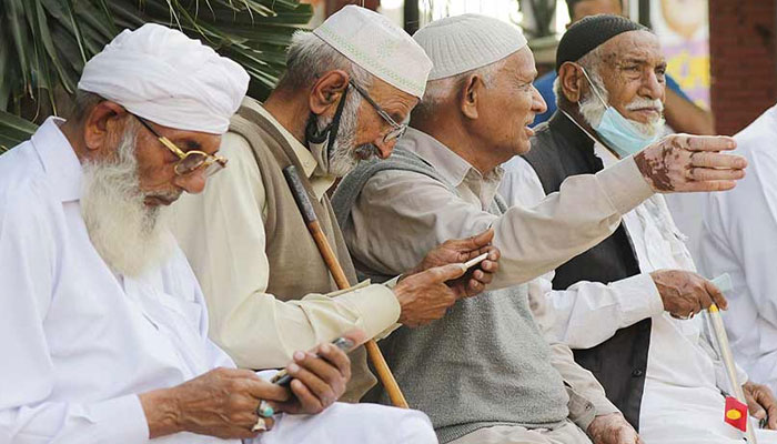 This representational image shows elders using mobile phones. — The News International/File