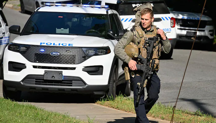An armed security personnel walks by at the site of an incident. — Anadolu/File