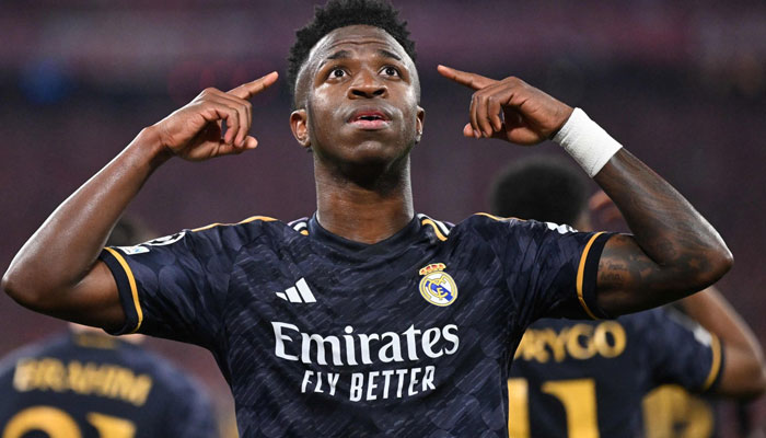 Real Madrids Vinicius Junior celebrates scoring a penalty during the UEFA Champions League semifinal first leg football match against Bayern Munich on April 30, 2024. — AFP
