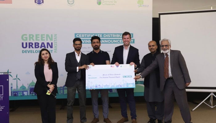Participants hold price cheque in this image. — APP/File