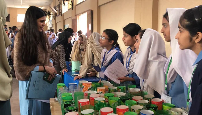 Students of the Church Mission School, located in the heart of Karachi’s old city area, brief a judge about the low-cost sustainable cooling solution theyre created. — The News File