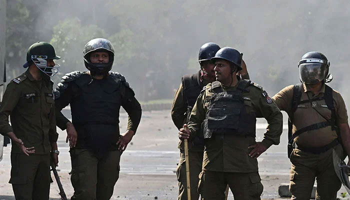 Policemen stand guard on the road in Lahore. — AFP/File