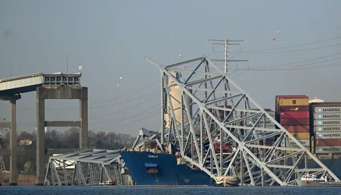 The collapsed Francis Scott Key Bridge lies on top of the container ship Dali in Baltimore, Maryland, on March 29, 2024. — AFP File