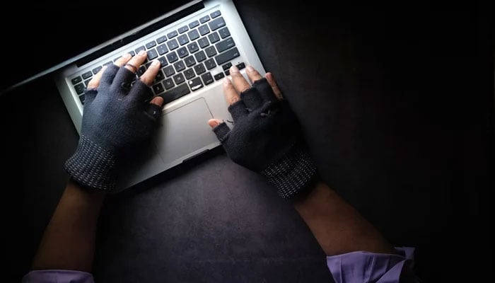 The representational image of a hacker using a laptop. — Unsplash