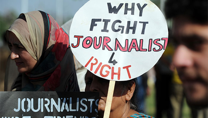 A representational image showing people holding placards for journalists rights. — AFP/File