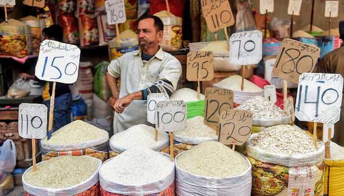 A shopkeeper waits for customers at a market in Karachi. — AFP/File