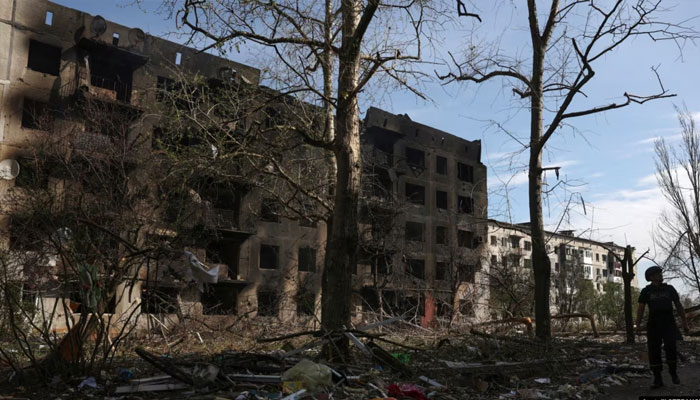 A man passes houses destroyed by artillery fire and air raids in the village of Ocheretyne in the Donetsk region in mid-April.— AFP/File