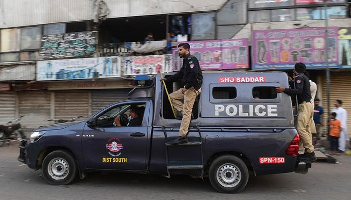 A representational image Police personnel patrolling Karachi sreets. — AFP/File