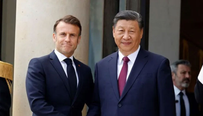 French President Emmanuel Macron accompanies Chinas President Xi Jinping as he leaves after a trilateral meeting at the Elysee Palace in Paris as part of the Chinese presidents two-day state visit in France, May 6, 2024. — Reuters
