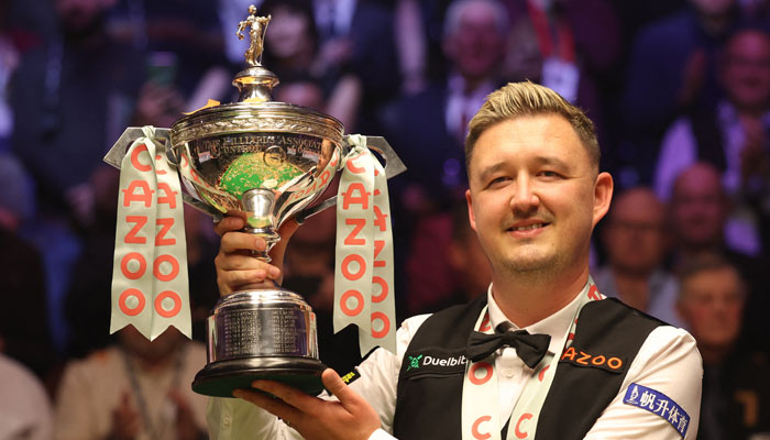 Englands Kyren Wilson poses with the trophy after winning his final match against Wales Jak Jones during the World Snooker Championship on May 6, 2024. — Reuters