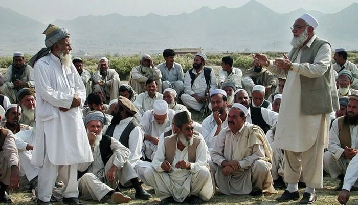 A representational image shows members sitting while an elder speaks. — AFP/File