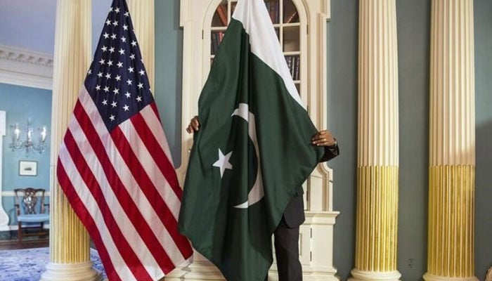 A State Department contractor adjust a Pakistan national flag at the State Department in Washington. — Reuters/File