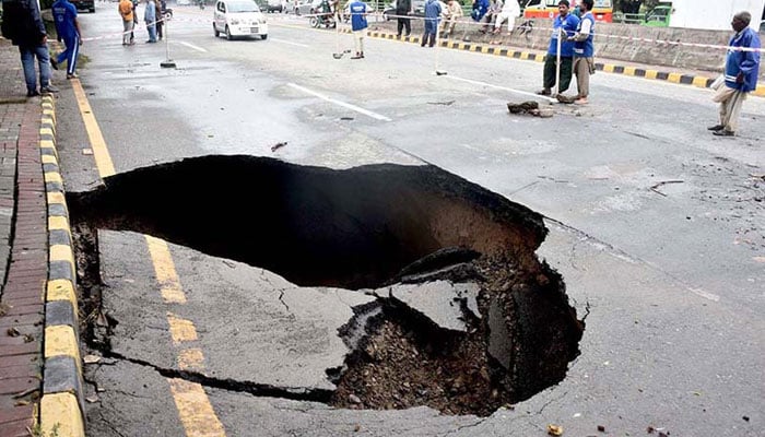 This representational image shows a view of road collapse due to heavy rain in the city. — APP/File