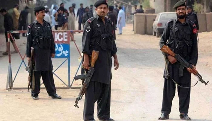 A photo of Khyber Pakhtunkhwa police personnel standing guard at a checkpoint. — APP/File