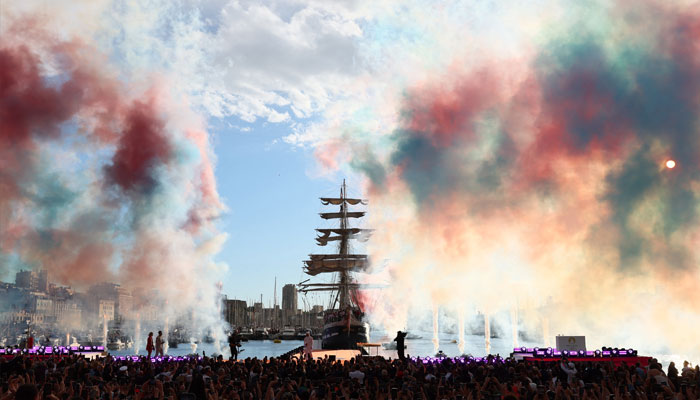 General view of colored smoke as French rapper Julien Mari is seen after the Olympic Flame was lit at the Old Port ahead of the Paris Olympics 2024.— Reuters/File