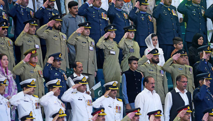 This representational image shows Pakistani armed forces officials salute as they listen to the national anthem during the Independence Day ceremony in Islamabad. — AFP/File