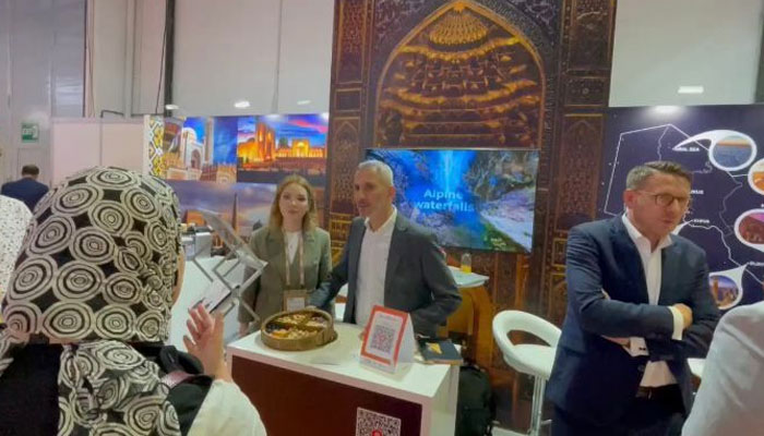 People attend a stall regarding Uzbekistans tourism potential at an exhibition. — Reporter/File