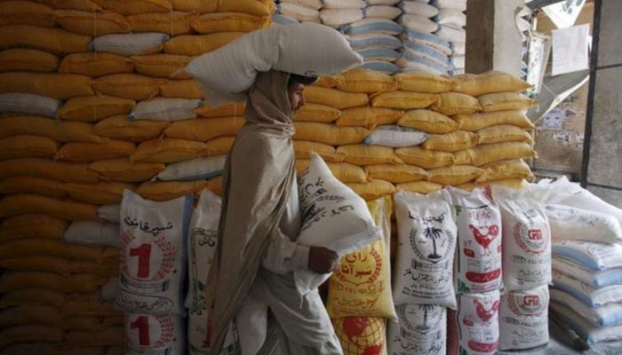 In this file photo, a man carried a bag of flour. — Reuters/File