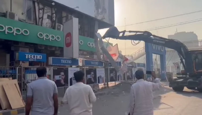 In this still, LDA and TEPA workers conduct a joint operation against violations of parking regulations and illegal signboards on May 9, 2024. — Facebook/Lahore Development Authority