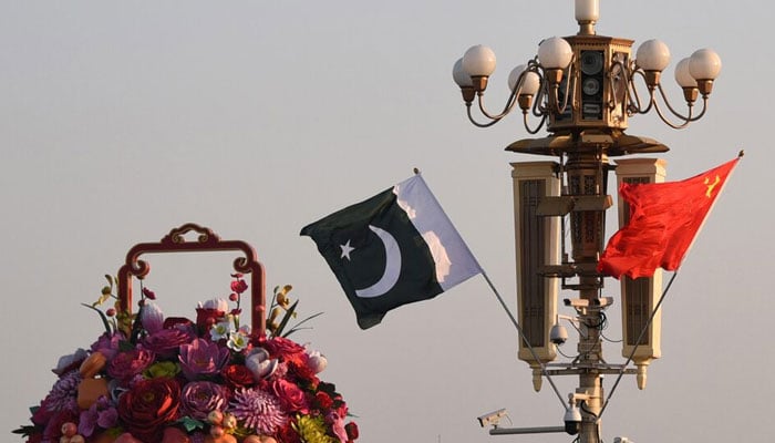 Pakistani and Chinese national flags flutter next to an installation featuring a giant flower basket at Tiananmen Square in Beijing, China. — REUTERS/File