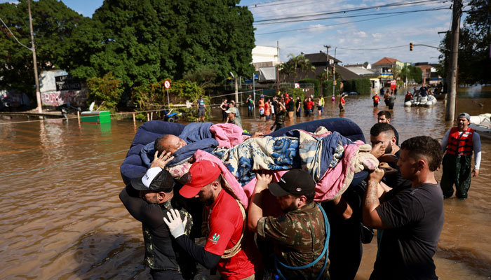 A woman is evacuated from her flooded home in Humaita, in Porto Alegre, Rio Grande do Sul, Brazil May 8, 2024. — Reuters