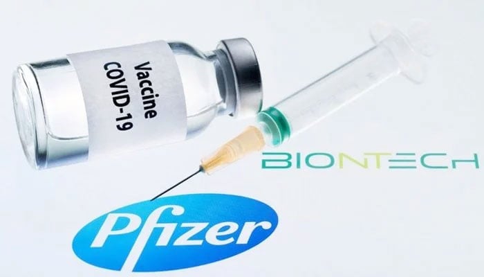 Photo showing a vial of the coronavirus vaccine along with a syringe, while the logos of pharmaceutical companies Pfizer and BioNTech SE could be seen in the background. — AFP/File