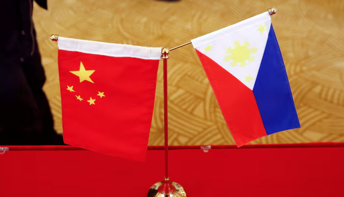 National flags are placed outside a room where Philippines finance secretary and Chinas commerce minster address reporters after their meeting in Beijing, China. — Reuters/File