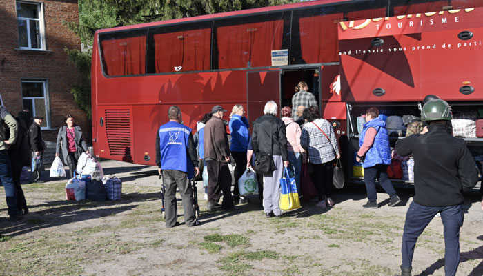 Ukrainian volunteers evacuate residents from settlements in the north of the Kharkiv region. — AFP/File