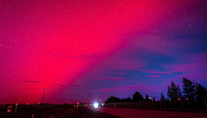 The Aurora Australis, also known as the Southern Lights, glow on the horizon over Punta Arenas, Chile, on May 10. — AFP