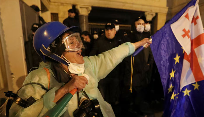 Demonstrators wave flags during a rally to protest against a bill on foreign agents in Tbilisi, Georgia, May 13, 2024. — Reuters