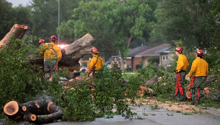 Houston Fire Department Wildland District 14 crews assess a downed tree blocking a street after a severe storm caused widespread damage in Spring Branch, Texas, U.S., May 17, 2024. — Reuters