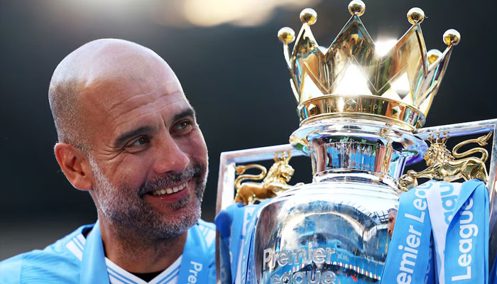 Manchester City manager Pep Guardiola celebrates with the trophy after winning the Premier League.—Reuters/file