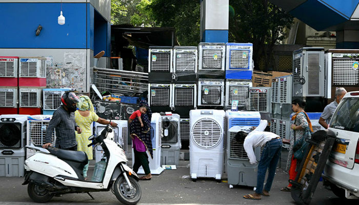 People buy air coolers from a roadside vendor on a hot summer afternoon in New Delhi on May 20, 2024, amid the ongoing heatwave. — AFP